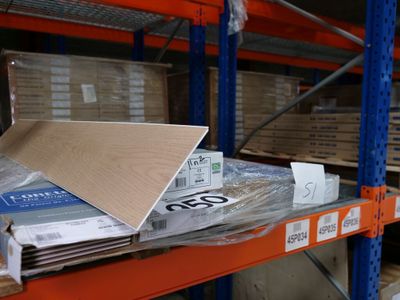 a laptop computer sitting on top of a shelf in a warehouse