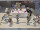 a lot of watches on display in a glass case