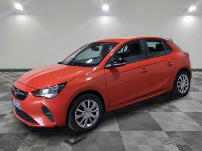 a red car is parked in a room with a checkered floor