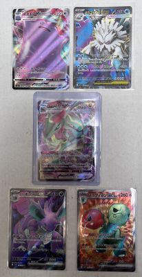 pokemon cards are lined up in a row on a white surface