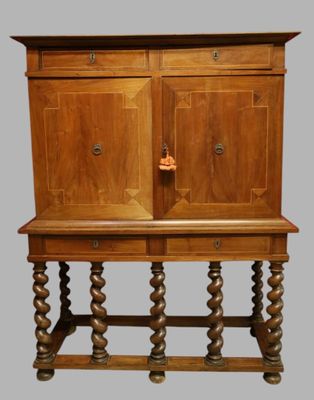 a wooden cabinet with two doors on top of it