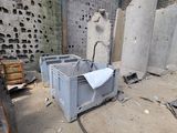 a pile of concrete blocks in a building with a broken window