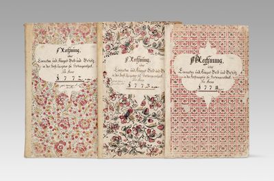 an open book with a floral design on the cover