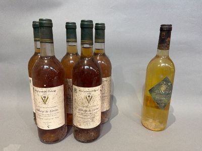 three bottles of wine and a bottle of wine sitting on a table