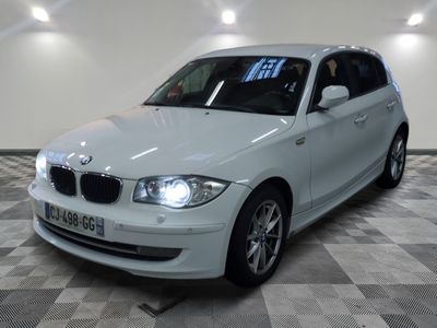 a picture of a white bmw car in a showroom