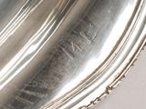 a close up of a silver plate on a table