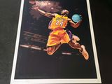 a framed photograph of a basketball player with a ball in his hand