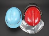 two hard hats sitting next to each other on a table