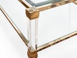 a glass coffee table with a gold base and a clear glass top