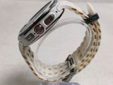 a close up of a watch on a clear stand