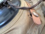 a close up of a brown bag with a leather strap