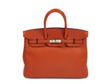 the hermes bag in orange leather with silver hardware