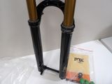 a pair of black and gold forks on a white table