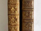 two old books that are sitting on a table