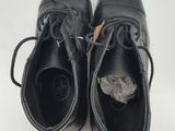 pair of black leather shoes with laces on them on a white surface