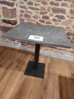 a small table with a number on it in front of a stone wall