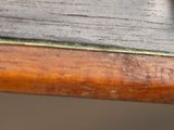 a close up of a wooden stick with a knife on top of it