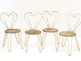 four chairs with hearts on them sitting on a white surface