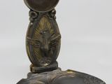 brass plate with a bird on it and a mirror on top of it