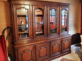 a large wooden bookcase with many books on it