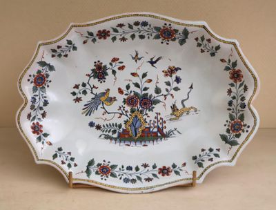 a plate with a bird and flowers design on it