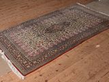 a rug on the floor in the middle of a room