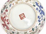 a white bowl with a red and blue design on it