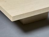 a square table with a wooden top on a gray surface