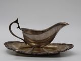 an antique silver plate with a saucer and saucer on it