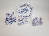 four pieces of blue and white pottery on a table