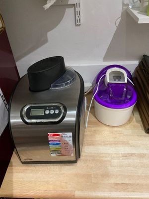 a small counter with a blender and other items on it
