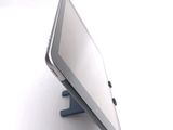 a tablet computer sitting on a stand on a white surface