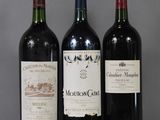 three bottles of wine sitting on a glass table