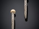 a pair of gold and diamond hoop earrings