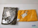 two sweaters that are sitting on a table