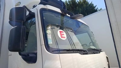a large white truck parked in front of a building