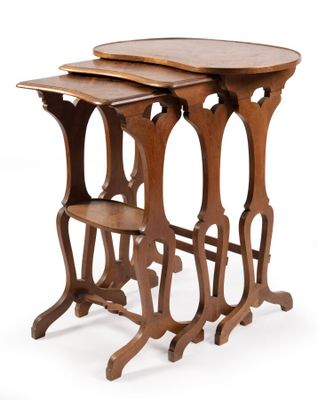 trois tables en bois sont empilées les unes sur les autres sur une surface blanche