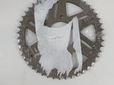 a close up of a bicycle chain with a piece of paper on it