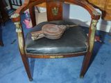 a chair with a hat on top of it next to a desk