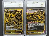 two pokemon trading cards in plastic cases on a black surface