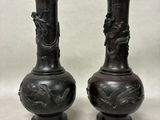 two vases that are sitting on a table