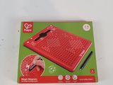 someone is using a pen to write on a red electronic keyboard