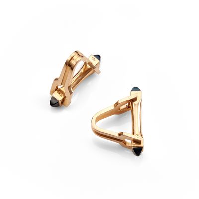 a pair of gold cufflinks on a white background