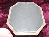 a picture of a metal plate on a purple blanket