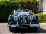an image of a classic car parked in front of a house