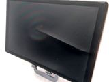 a tablet computer sitting on a stand on a white surface