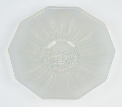 a clear glass plate with a sun design on it