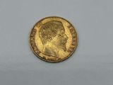 a gold coin with a man ' s face on it