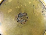 a close up of a gold plate with a coat of arms on it