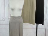 two skirts on a mannequin stand in a room